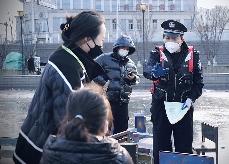 天津市公安局治安管理总队民警现场向游玩穿行冰面市民发放《致广大市民冬季一封信》。杨娃娃摄