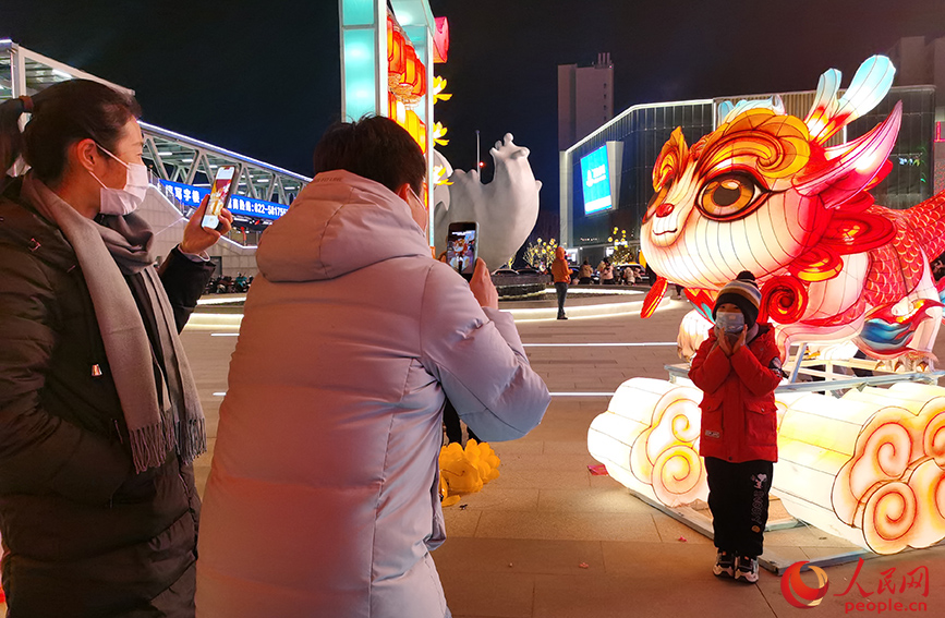 2023年12月31日，天津市民在西青大悅匯龍形燈飾前拍照留念。人民網記者 陶建攝