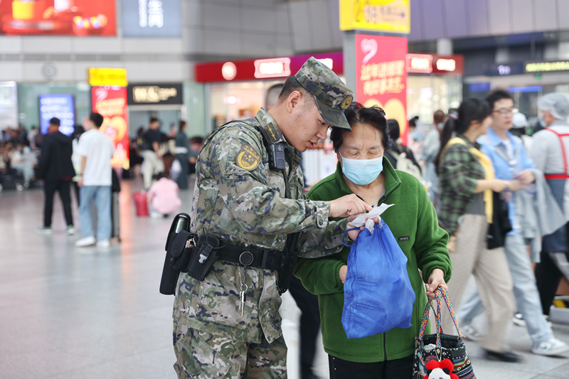 执勤官兵为旅客提供帮助。周旭升摄