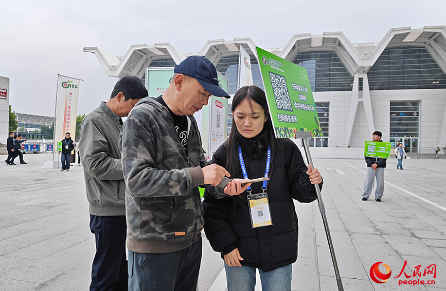 场馆外，志愿者协助参观市民预约门票。人民网记者 孙一凡摄