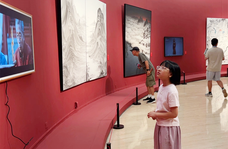 小朋友专心观看展出的AI电影。天津美术学院供图